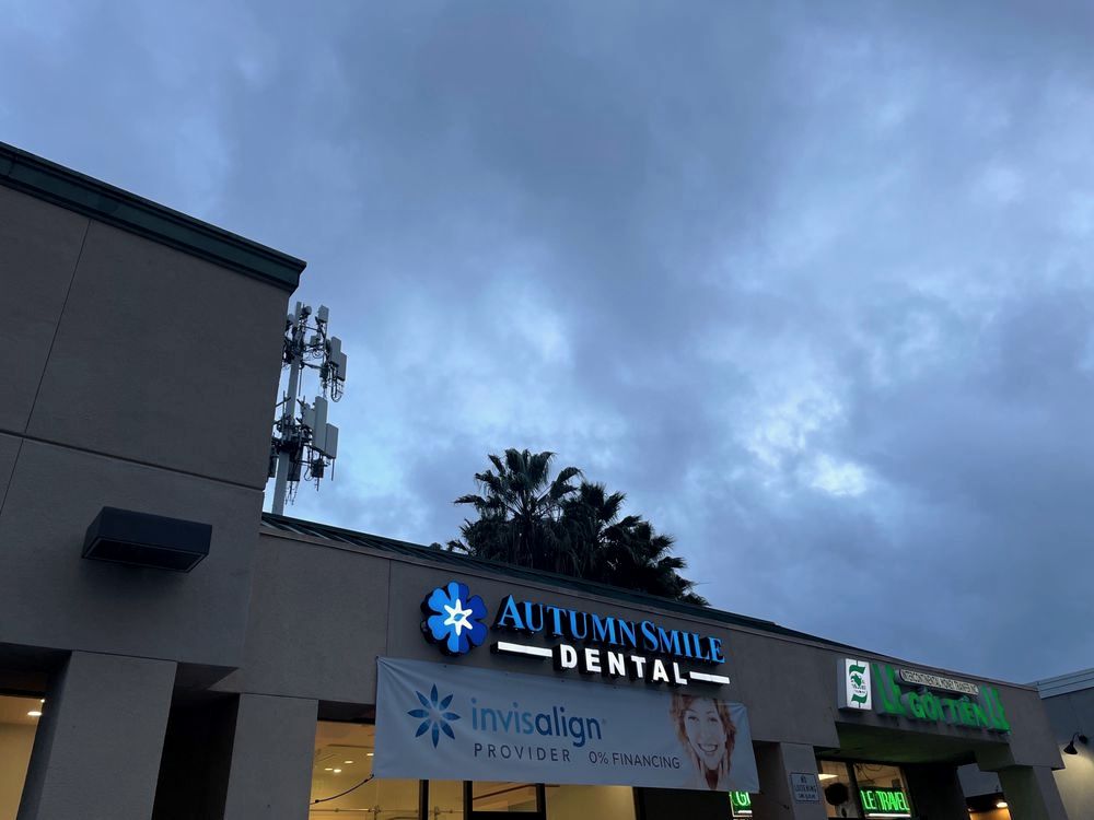 The Autumn Smile Dental sign on Tully Road at dusk