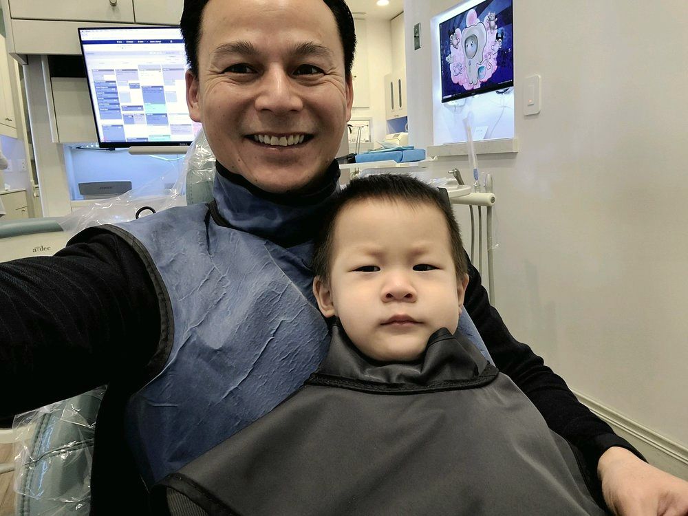 A dad and his son in the chair at Autumn Smile Dental