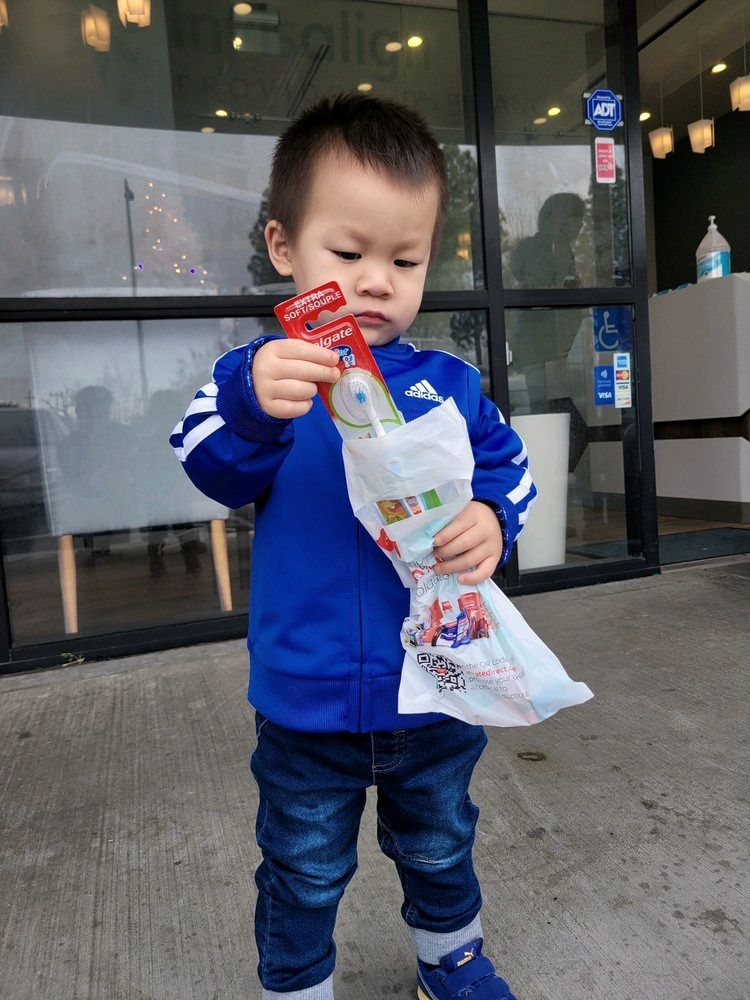 A young patient with his goodie bag after a visit