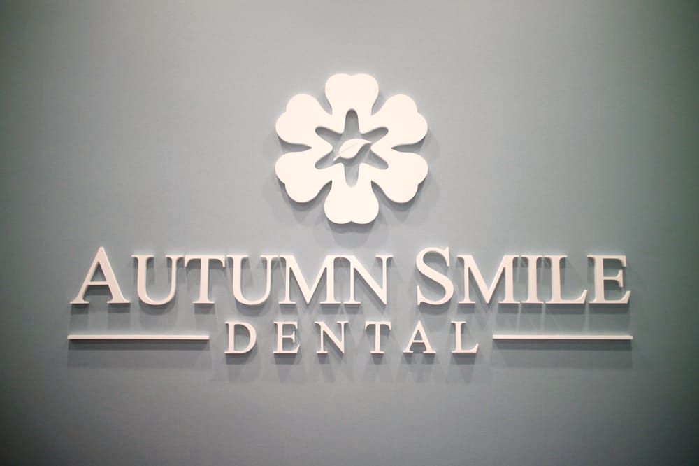 The Autumn Smile Dental logo wall behind reception