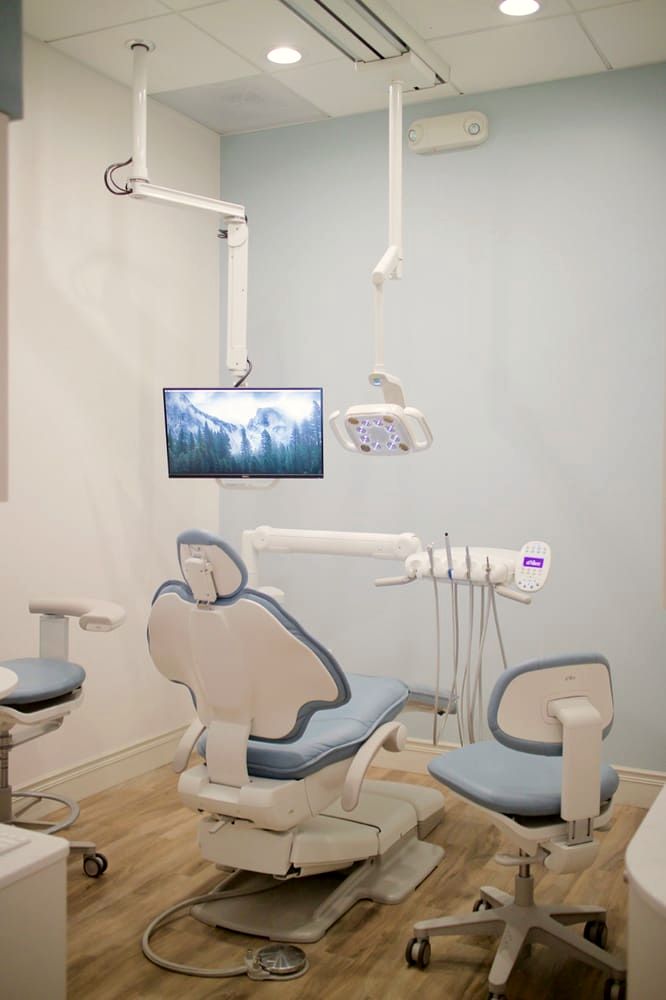 A treatment room with a sky-blue chair and new equipment
